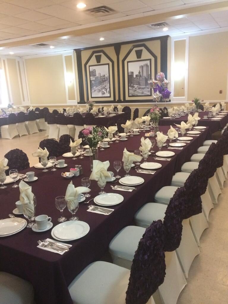 Long banquet table set with purple linens